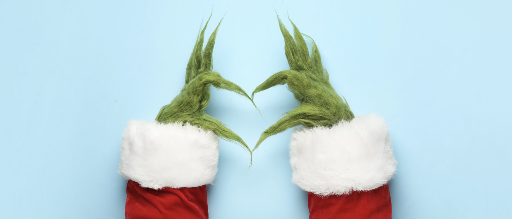 Grinch style green furry hands forming a heart shape